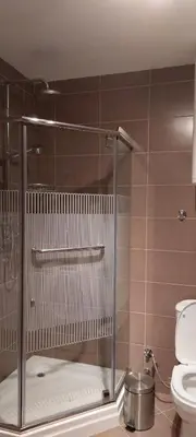 a bathroom with a toilet and a glass shower stall at Meseceva bajka 2 in Kopaonik