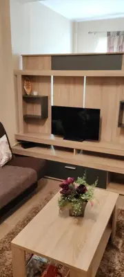 a living room with a coffee table with flowers on it at Meseceva bajka 2 in Kopaonik