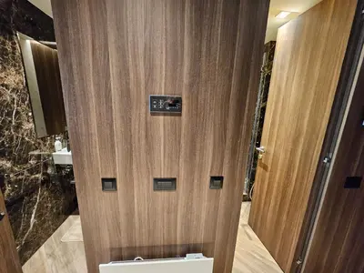 a bathroom with a wooden door with a sink at Kopaonik Woodside Hotel SKI - SPA in Kopaonik
