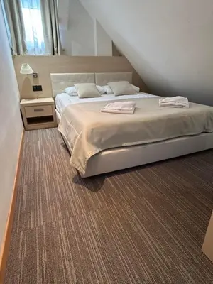 a bedroom with a bed with two towels on it at Pahulja in Kopaonik