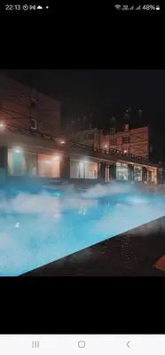 a large swimming pool at night with blue water at Ebra 75 Kraljevi Cardaci Kopaonik in Kopaonik