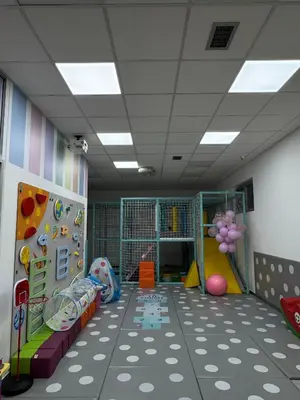 a room with a playroom with a slide and a climbing wall at Bed & Coffee LUKAS Krusevac in Kruševac