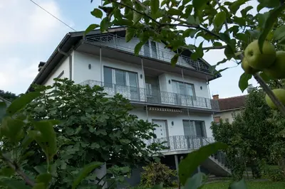 a white apartment building with a balcony at Vikend Kuća Živković in Despotovac
