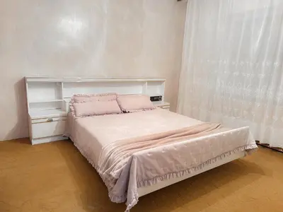a bedroom with a large bed with pink pillows at Vikend Kuća Živković in Despotovac