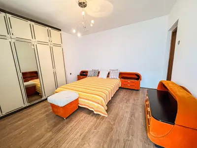 a bedroom with a bed and a desk and a chair at Vikend Kuća Živković in Despotovac