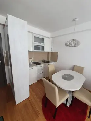 a kitchen with a table and chairs in a room at Tri srca - Kraljevi Cardaci in Kopaonik