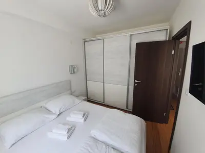 a bedroom with a bed with two towels on it at Tri srca - Kraljevi Cardaci in Kopaonik