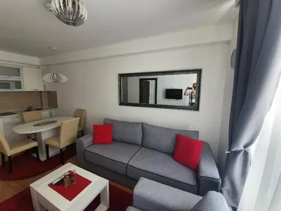 a living room with a couch and a table and a mirror at Tri srca - Kraljevi Cardaci in Kopaonik