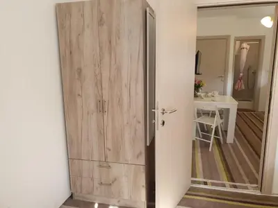 a wooden door in a room with a hallway at Vila LELA in Vrnjačka Banja