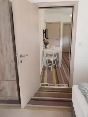 a door leading into a room with a table at Vila LELA in Vrnjačka Banja
