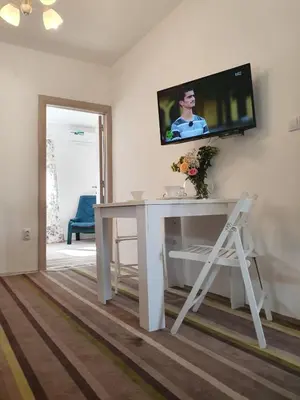 a white desk with a television on a wall at Vila LELA in Vrnjačka Banja