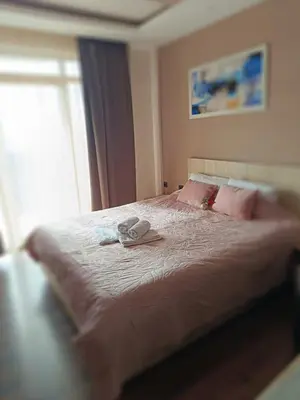 a bedroom with a large bed with pink pillows at Milmari M9 in Kopaonik