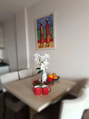 a table with a vase of flowers and fruit on it at Milmari M9 in Kopaonik