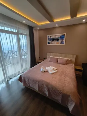 a bedroom with a bed with a robe on it at Milmari M9 in Kopaonik