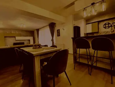 a living room with a wooden table and chairs at Prelepa prostrana kuća in Šipačina
