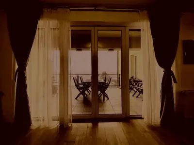 a room with a sliding glass door with a table outside at Prelepa prostrana kuća in Šipačina