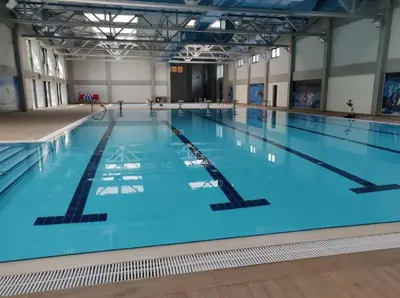 a large indoor swimming pool with blue water at APARTMAN PLAVA LAGUNA -Crnjanski in Jagodina