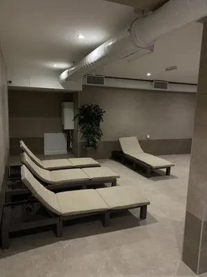 a hospital room with several beds and a plant at Lawa Apartments Kopaonik in Cajetina