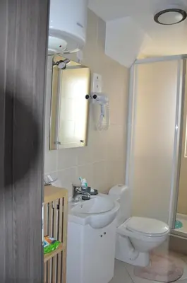 a bathroom with a toilet and a sink and a mirror at Studio SimpaKop in Kopaonik