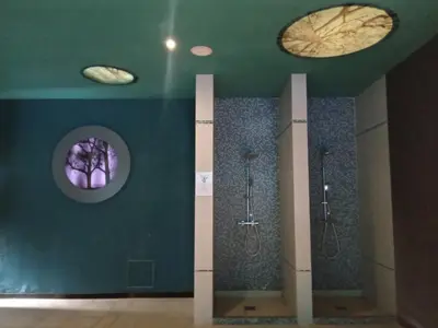 a bathroom with three urinals and three sinks in a room at Studio SimpaKop in Kopaonik