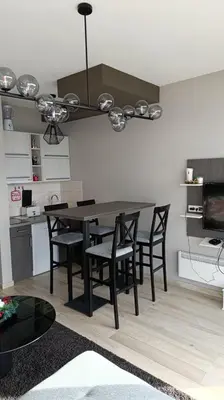 a kitchen with a dining room table and chairs at Apartment Mountain View Haven in Kopaonik