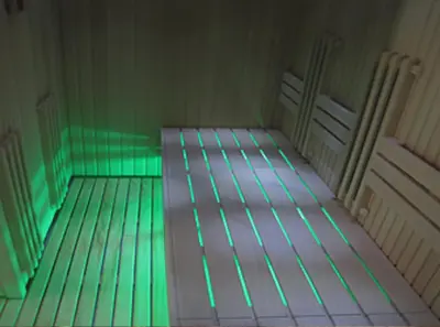 an empty room with green lights on a bed at Apartment Mountain View Haven in Kopaonik