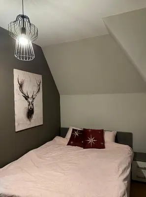 a bedroom with a bed with a deer on the wall at Apartment Mountain View Haven in Kopaonik