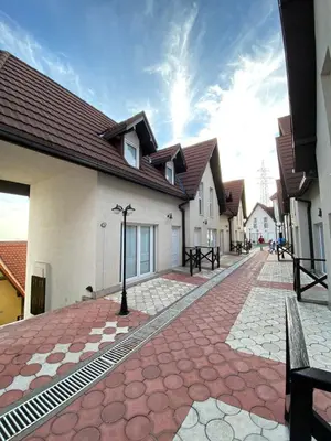 a cobblestone street in front of a building at Apartmani Čardaci Kopaonik in Kopaonik