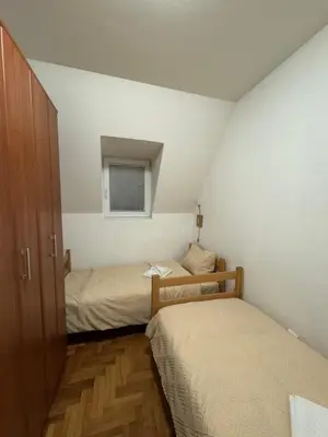 a small room with two beds and a window at Apartmani Čardaci Kopaonik in Kopaonik