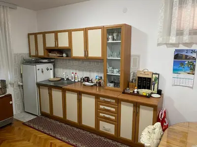 a kitchen with a counter and a refrigerator at Domacinstvo Markovic in Prekopčelica