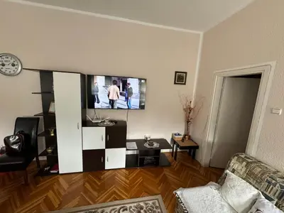a living room with a flat screen tv on the wall at Mimis place in Vrnjačka Banja