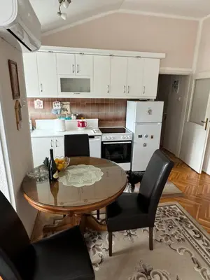 a kitchen with a table and chairs in a room at Mimis place in Vrnjačka Banja