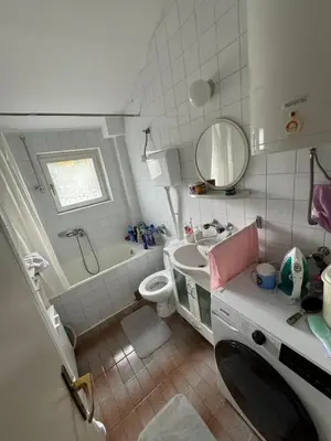 a small bathroom with a sink and a toilet at Mimis place in Vrnjačka Banja