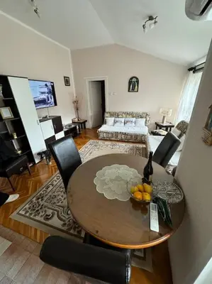 a living room with a table and chairs and a couch at Mimis place in Vrnjačka Banja