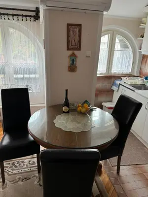 a kitchen with a dining room table and chairs at Mimis place in Vrnjačka Banja