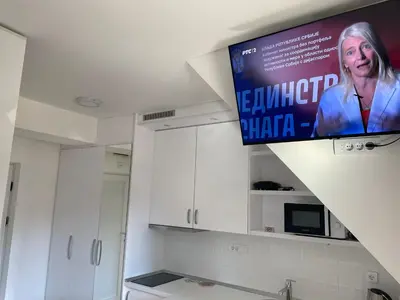 a tv hanging from a ceiling in a kitchen at Apartments Sia-M3 in Kopaonik