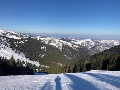 a shadow of a person standing on a snow covered mountain at Apartments Sia-M3 in Kopaonik