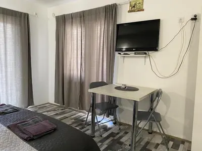a room with a desk and a tv on the wall at Studio Zverko in Soko Banja