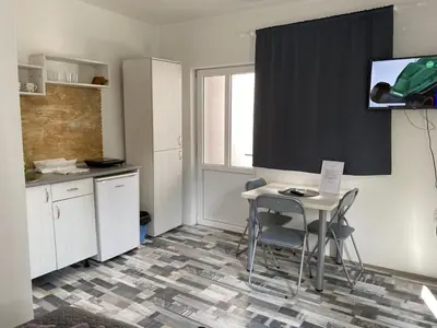 a kitchen with a table and chairs and a window at Studio Zverko in Soko Banja