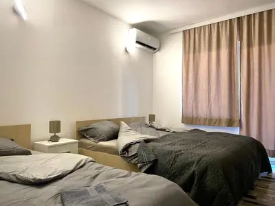 a room with two beds and a window at Studio Zverko in Soko Banja