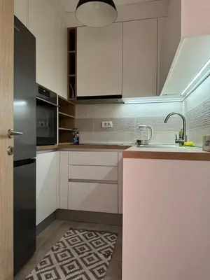 a kitchen with white cabinets and a sink at Apartman Petrovic in Vranje