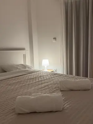a white bed with two white towels on it at Apartman Petrovic in Vranje