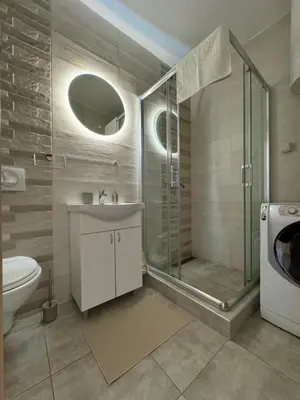 a bathroom with a shower and a sink and a toilet at Apartman Petrovic in Vranje