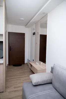 a living room with a couch and a wooden floor at Residence Hill A037 Apartment in Kopaonik