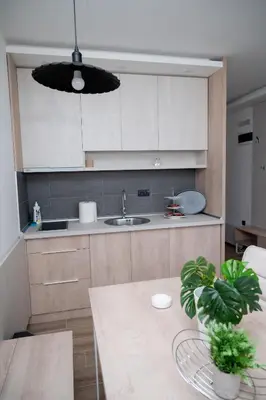 a kitchen with a table and a sink at Residence Hill A037 Apartment in Kopaonik