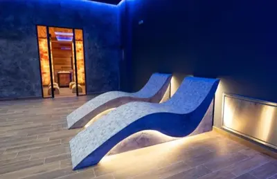two benches sitting in a room with a building at Apartman Magdalena Kopaonik in Cajetina