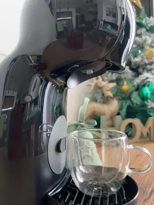 a coffee maker with a glass cup on a table at Apartman Magdalena Kopaonik in Cajetina