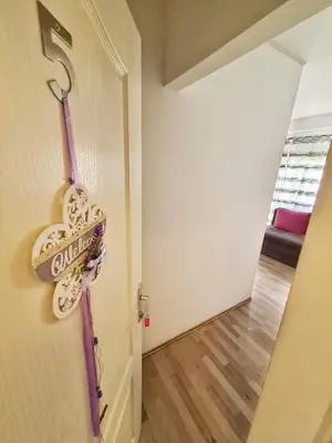 a door with a sign on it next to a hallway at Maja Vujković Apartman 5 in Soko Banja