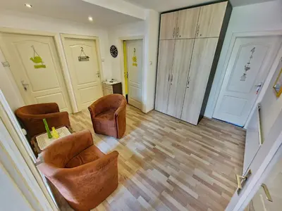 a living room with two chairs and a cabinet at Maja Vujković Apartman 1 in Soko Banja