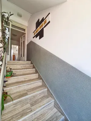 a staircase in a house with wooden floors at Maja Vujković Apartman 1 in Soko Banja